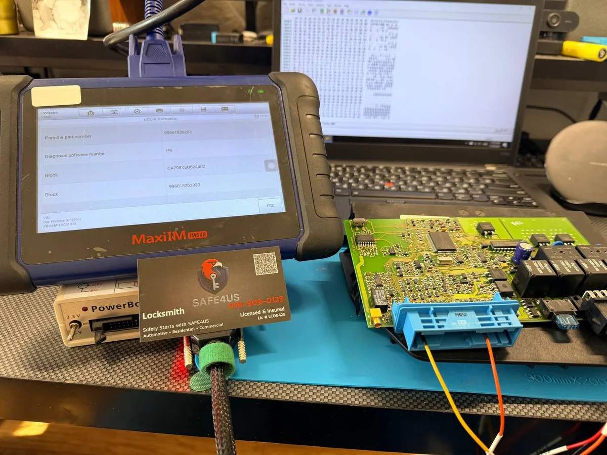 Diagnostic tablet displaying Porsche module data beside a circuit board and laptop during ECU programming