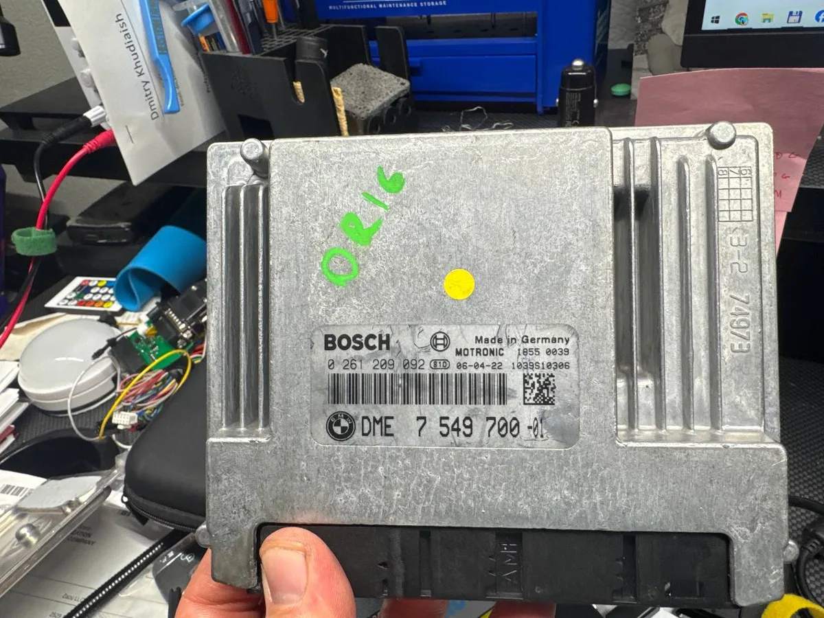 BMW DME engine control module on the bench during ECU programming work